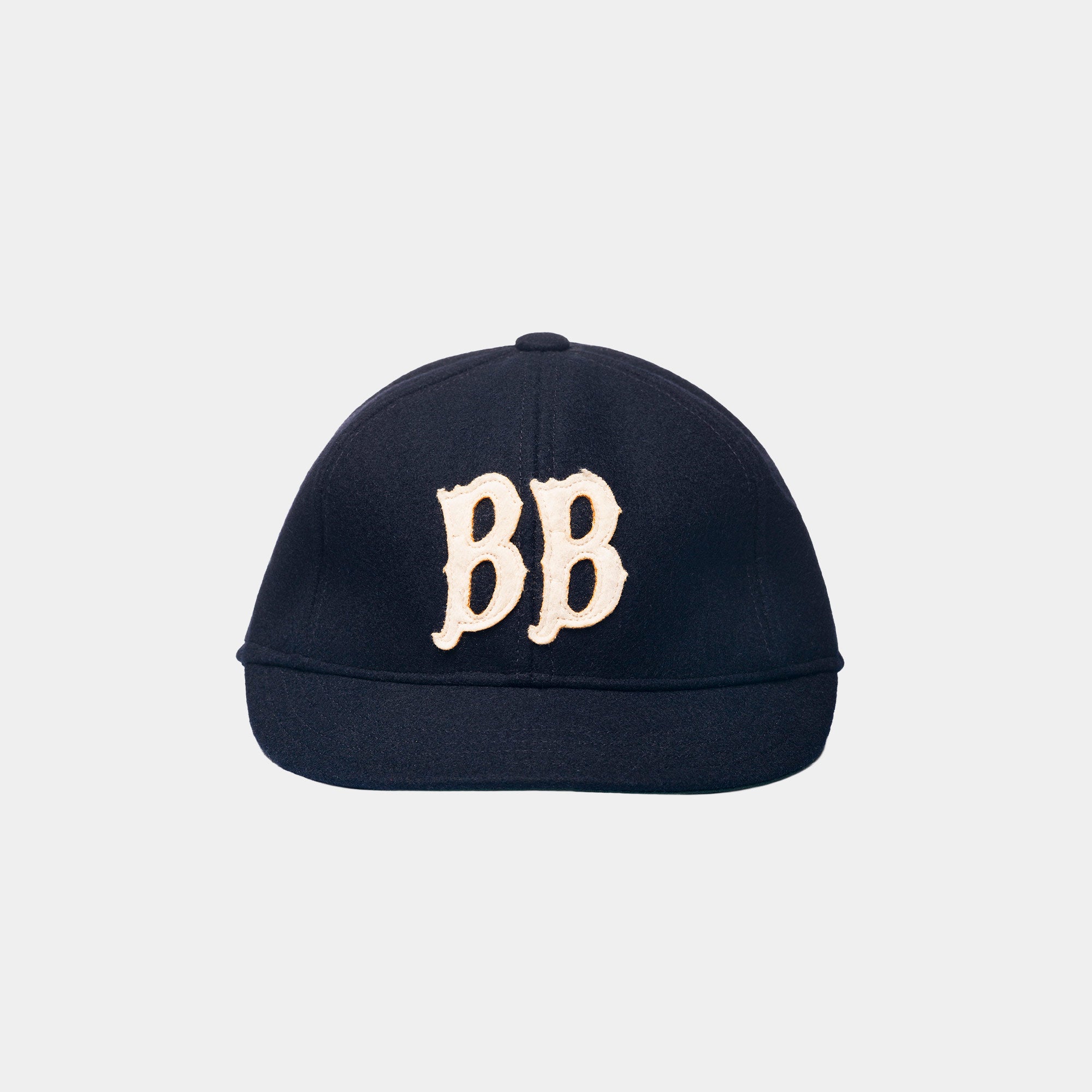 Side view of the BB Wool Cap by Blue Blanket, unstructured crown and curved brim in dark navy wool.
