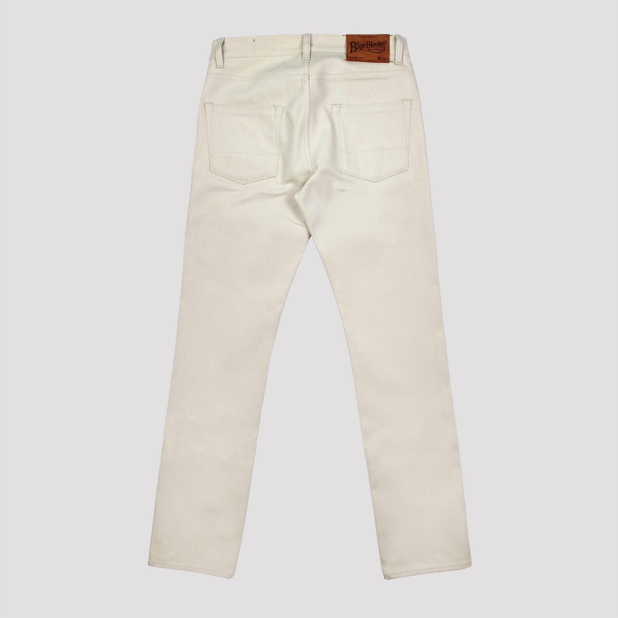 Beige pants with a brand label on a white background
